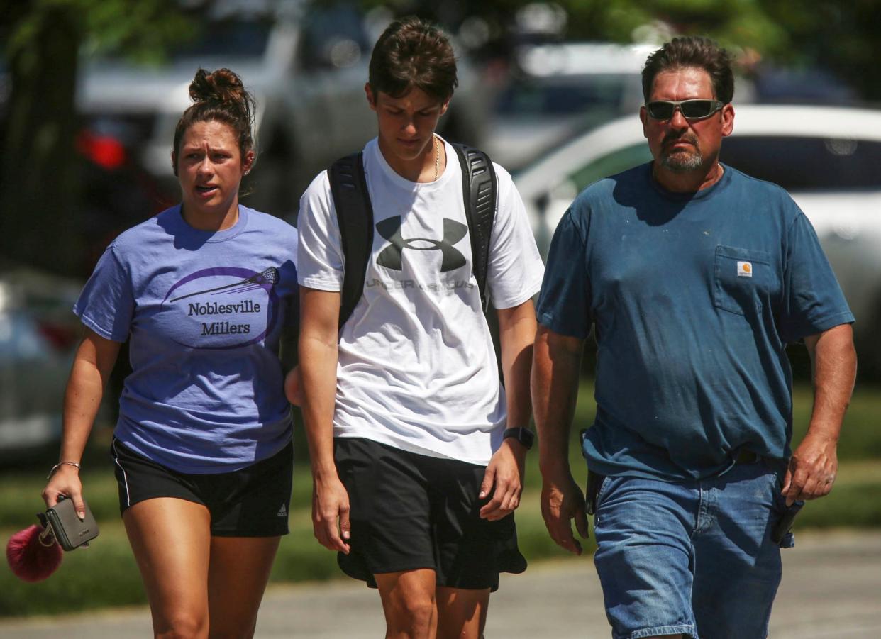 Students near the school after the attempted shooting yesterday: AP