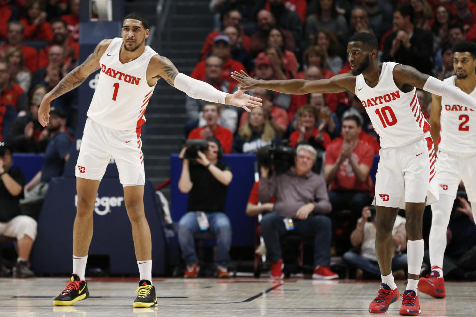 Dayton forward Obi Toppin (1) is congratulated for his 3-point basket against Davidson by guard Jalen Crutcher (10) during the first half of an NCAA college basketball game Friday, Feb. 28, 2020, in Dayton, Ohio. (AP Photo/Gary Landers)