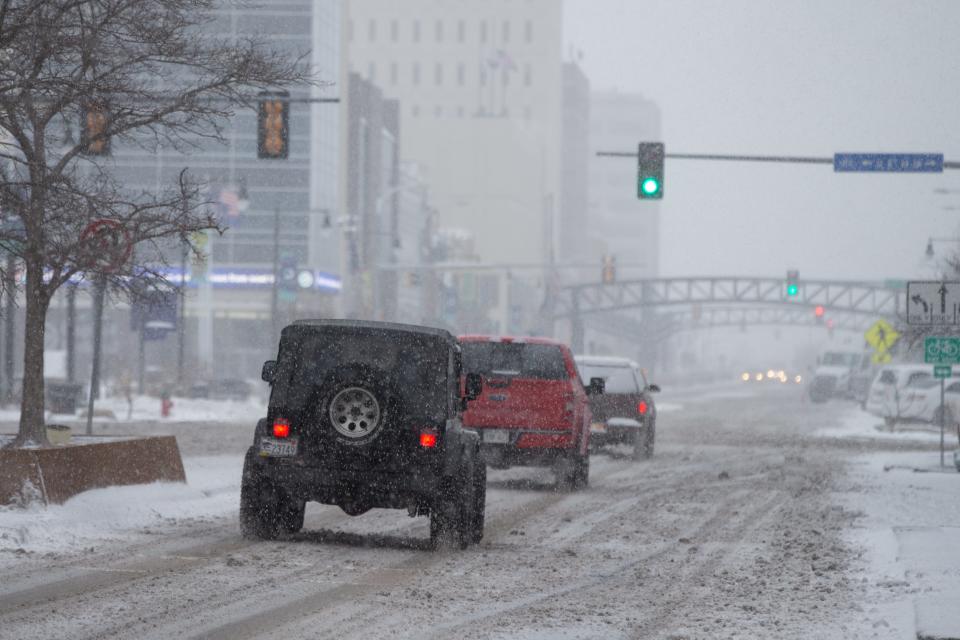 Traffic moves slowly along S. Kansas Avenue in downtown Topeka last March. The Farmers' Almanac predicts Kansans will again see considerable snow and cold weather during the upcoming winter.