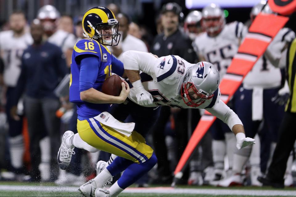 Los Angeles Rams' Jared Goff (16) gets sacked by New England Patriots' Kyle Van Noy (53) during the first half of the NFL Super Bowl 53 football game Sunday, Feb. 3, 2019, in Atlanta. (AP Photo/John Bazemore)