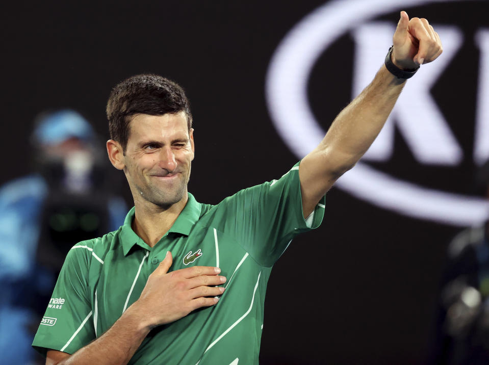 Serbia's Novak Djokovic celebrates after defeating Germany's Jan-Lennard Struff in their first round singles match the Australian Open tennis championship in Melbourne, Australia, Monday, Jan. 20, 2020. (AP Photo/Lee Jin-man)