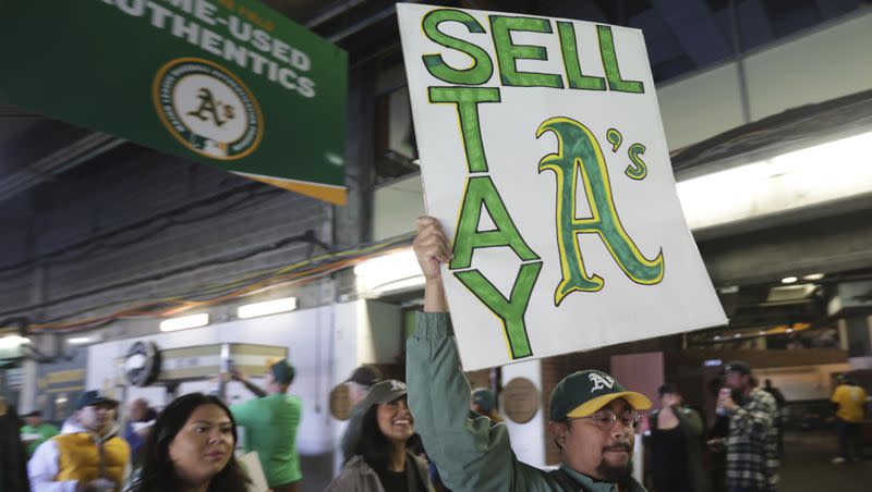 A fan holds a sign to protest the Oakland Athletics’ planned move to Las Vegas, before a baseball game between the Athletics and the Tampa Bay Rays in Oakland, Calif., Tuesday, June 13, 2023.
