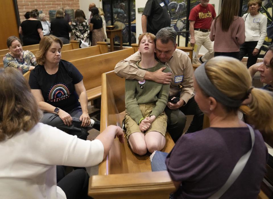 Jess Trias (right) comforts Sol Oglesby-Dunegan, 13, after the teen shared his story during a civic academy on youth mental health in Chandler on March 13, 2023.