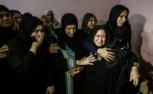 Relatives mourn for one of three Palestinians killed by Israeli fire along the border with the Gaza Strip