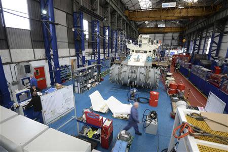 Employees of Soil Machine Dynamics (SMD) work on a subsea mining machine being built for Nautilus Minerals at Wallsend, northern England April 14, 2014. REUTERS/ Nigel Roddis