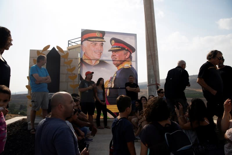 A picture of Jordanian King Abdullah and his father, the late King Hussein, is seen as people visit the "Island of Peace" in an area known as Naharayim in Hebrew and Baquora in Arabic, on the Jordanian side of the border with Israel