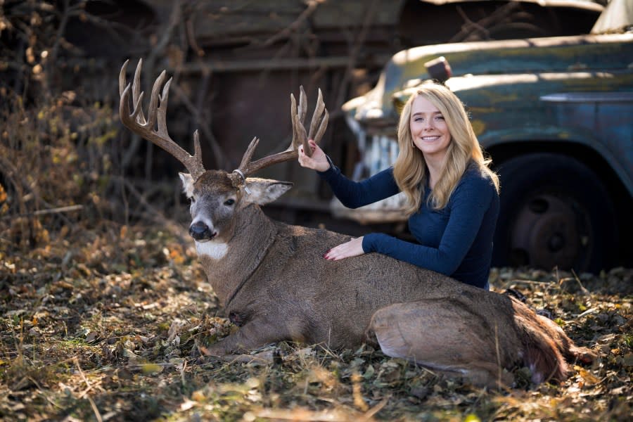 Samantha Camenzind poses with the deer she shot near Filley, Neb., before Cole Bures proposed to her on Nov. 12, 2023. Bures asked Camenzind to marry him during a photo shoot to commemorate the moment. (Brenton Lammers/Lammers Media via AP)