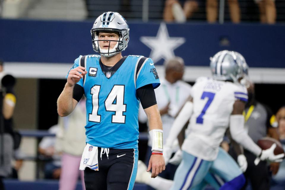 Carolina Panthers quarterback Sam Darnold walks to the sideline as Dallas Cowboys' Trevon Diggs (7) celebrates intercepting Darnold's pass in the second half of an NFL football game in Arlington, Texas, Sunday, Oct. 3, 2021. (AP Photo/Michael Ainsworth)