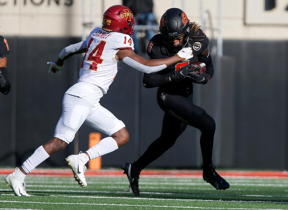 Nov 12, 2022; Stillwater, Oklahoma, USA;  Oklahoma State's Nickolas Martin (4) tries to get by Iowa State's Dimitri Stanley (14) defends in the first half during the college football game between the Oklahoma State Cowboys (OSU) and the Iowa State Cyclones at Boone Pickens Stadium. OSU won 20-14. Mandatory Credit: Sarah Phipps-USA TODAY Sports