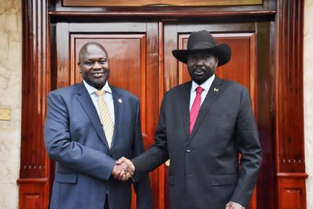 South Sudan's President Salva Kiir Mayardit shakes hands with ex-vice president and former rebel leader Riek Machar during their meeting in Juba