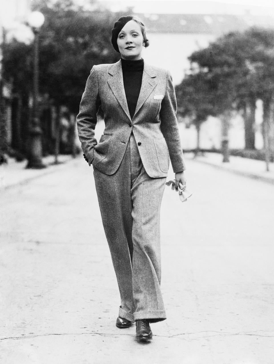 Dietrich strolls along Hollywood Street in a gray man's suit with turtleneck sweater in this undated photo, circa 1933.