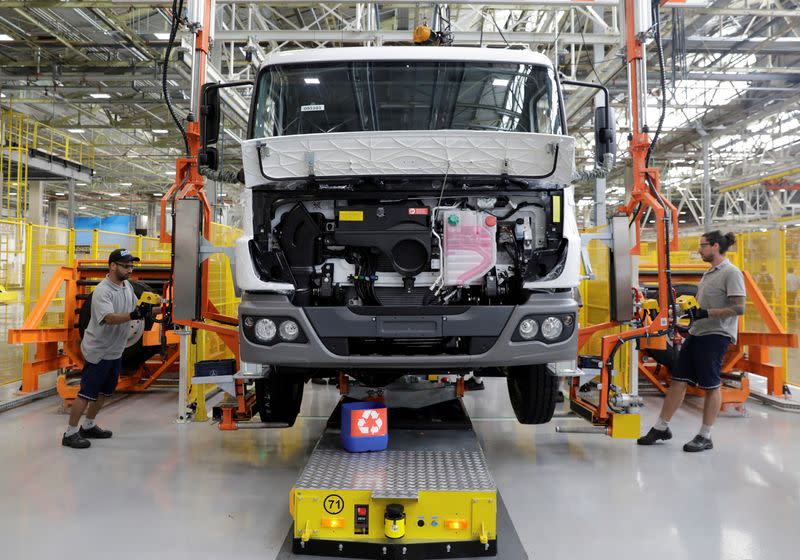 FILE PHOTO: Employees work on the new assembly line to build trucks at Mercedes Benz's trucks and buses manufacturing plant in Sao Bernardo do Campo