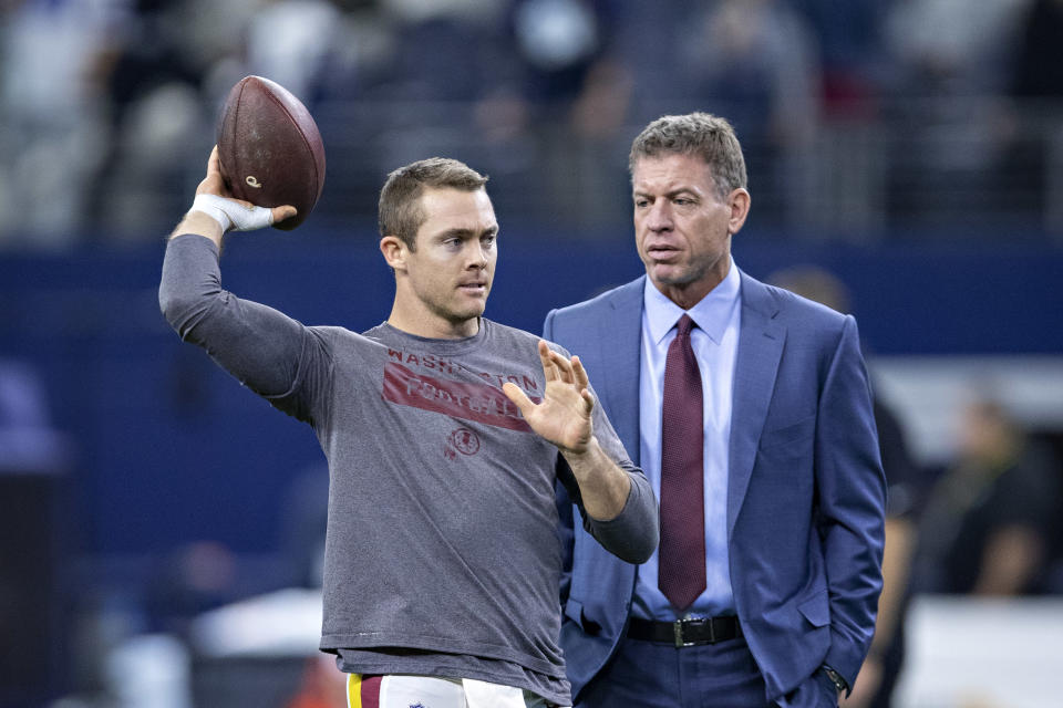 Troy Aikman and Redskins quarterback Colt McCoy share a moment before a Thanksgiving game this past season. (Getty Images)