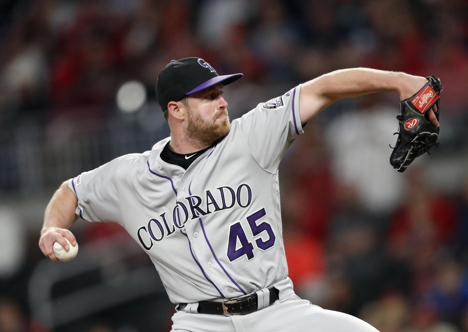 FILE - Colorado Rockies relief pitcher Scott Oberg (45) works in the eighth inning of a baseball game against the Atlanta Braves in Atlanta, in this Friday, April 26, 2019, file photo. No one's giving Colorado much of a chance — especially their disgruntled fans — after a blockbuster deal sent eight-time Gold Glove winner Arenado to St. Louis. That’s why Oberg, outfielder Ian Desmond, shortstop Trevor Story and some of the other clubhouse leaders reached out to teammates following the Arenado deal. Their message: Stick together.(AP Photo/John Bazemore, File)