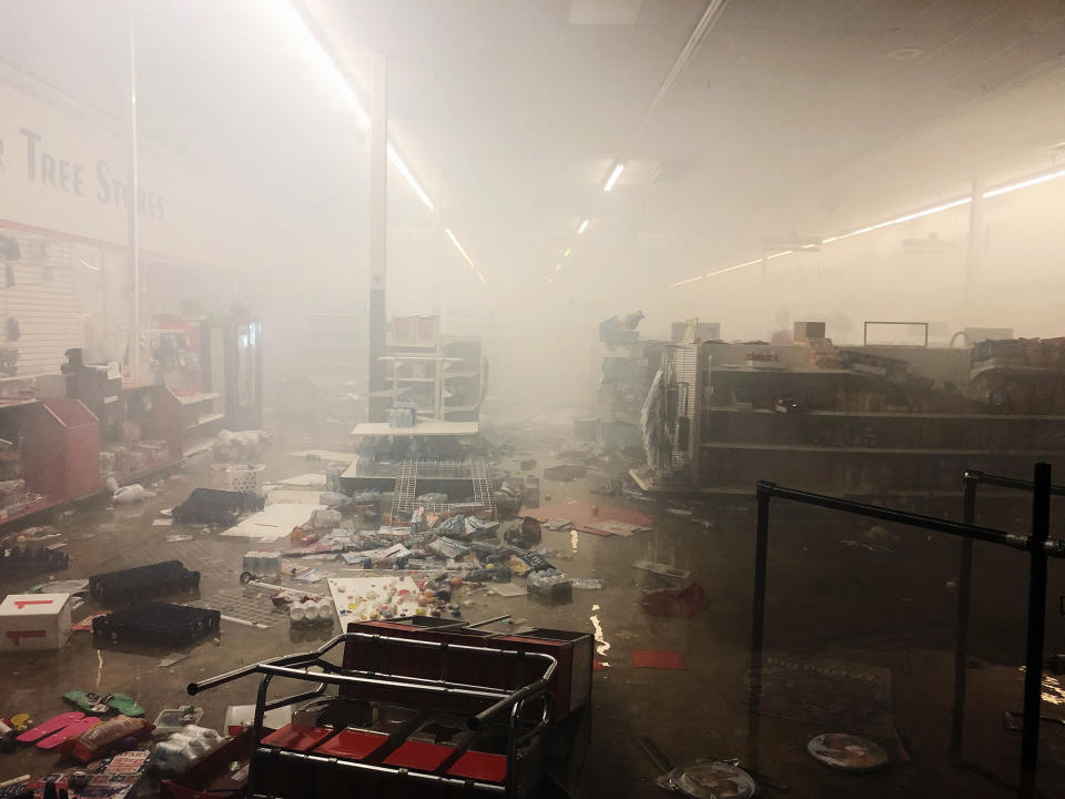 The remains of a Dollar Tree store smolders after protests in Minneapolis on May 28, 2020. | Patience Zalanga for TIME