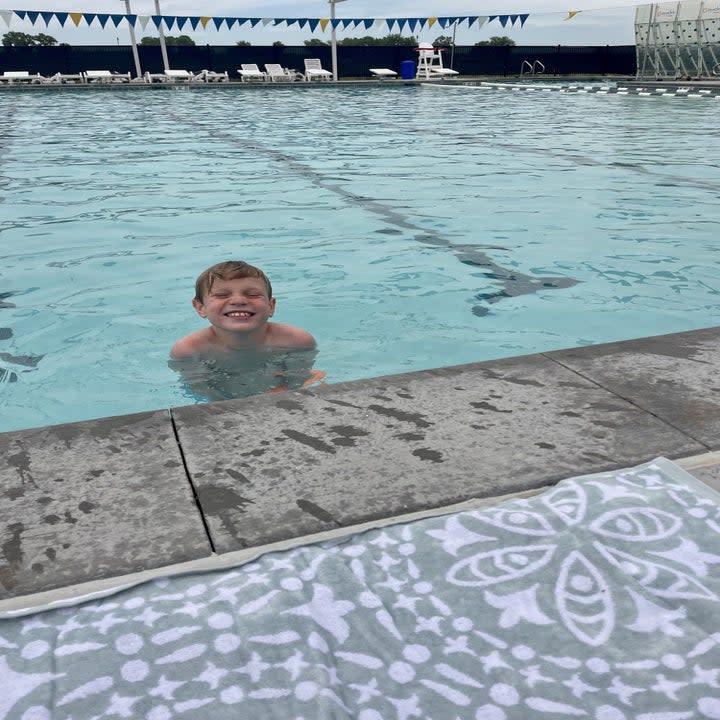 the author's son swimming in the pool