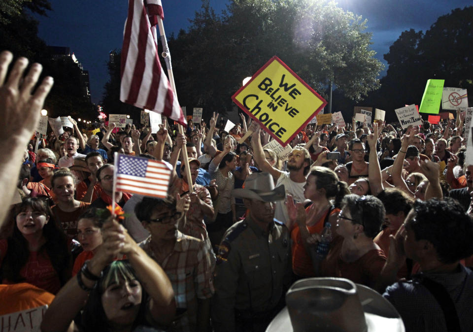 A nighttime view of a crowd of demonstrators