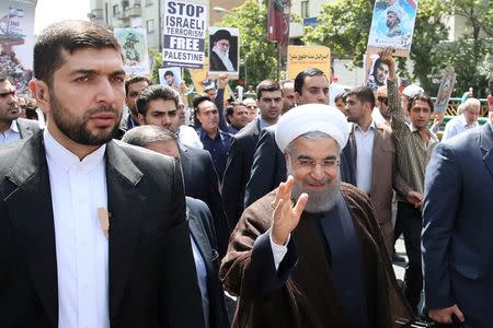 Iran's President Hassan Rouhani waves during a rally marking the international al-Quds day in support of the Palestinians, in Tehran, Iran July 1, 2016. President.ir/Handout via REUTERS