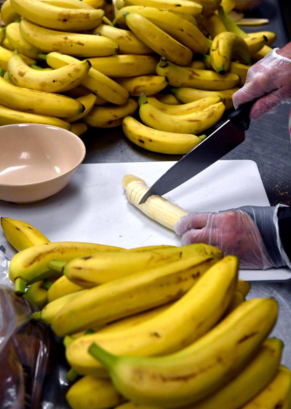 Tonya Williams, the kitchen manager at Vine Street Day Nursery, cuts bananas into slices suitable for tiny hands before lunch.