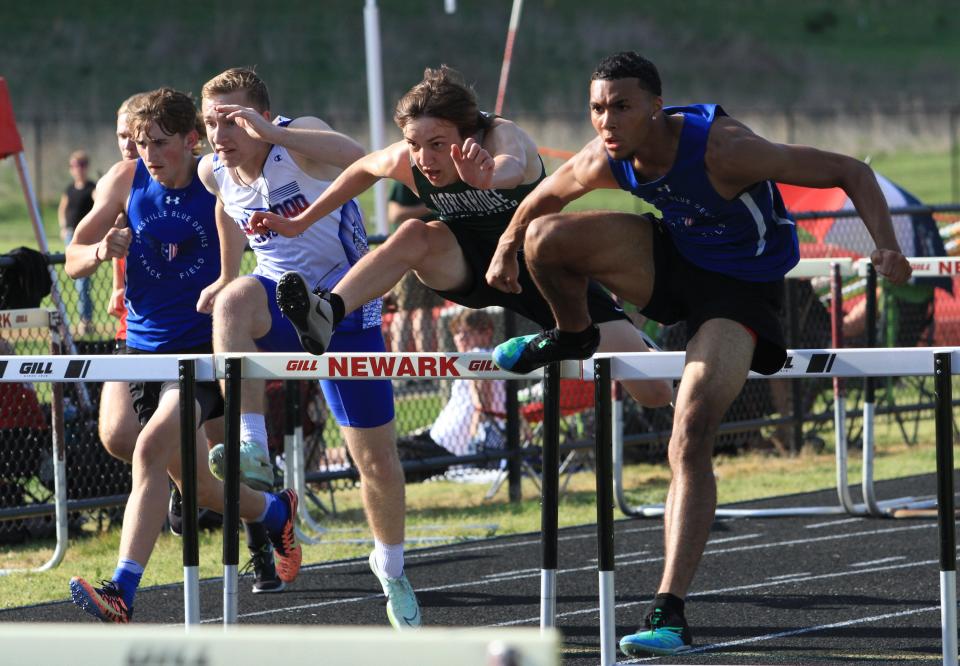 Northridge's Nathan Burkey, center, competes in the 110 hurdles at the Newark Catholic Invitational on Thursday.