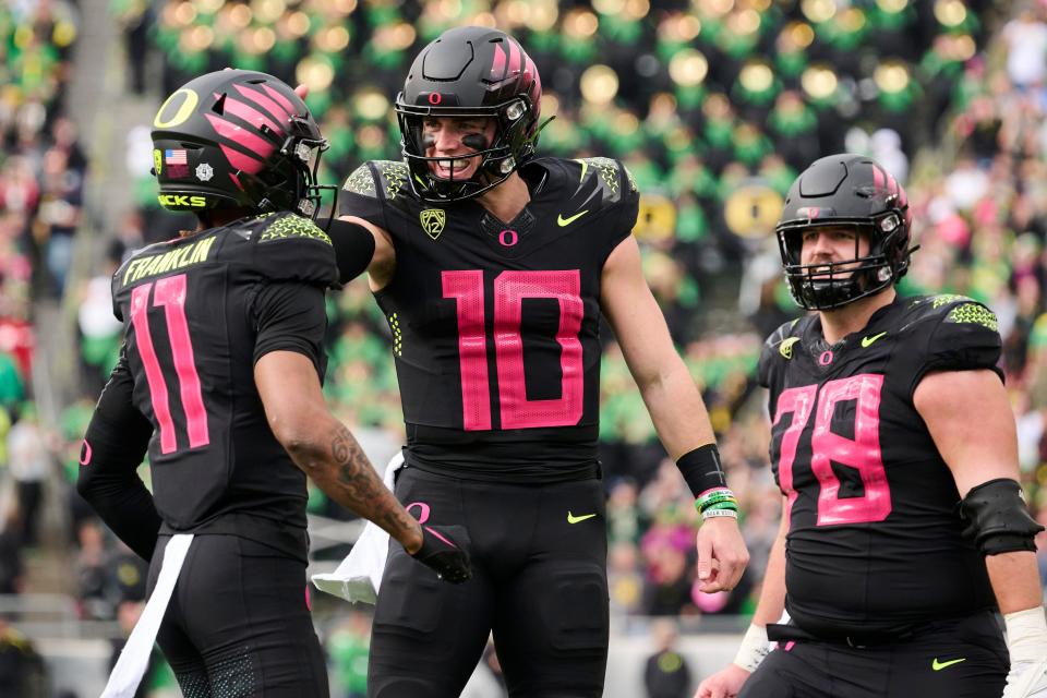 Oregon Ducks wide receiver Troy Franklin (11) celebrates with quarterback Bo Nix (10) after catching a touchdown pass during the first half against the UCLA Bruins at Autzen Stadium Oct. 22, 2022, in Eugene.