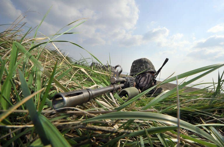 A South Korean soldier takes position during a joint landing operation by US and South Korean forces in Pohang, on April 26, 2013. South Korea says it has decided to withdraw all remaining staff from its joint industrial complex with North Korea for their own safety, after Pyongyang shunned an offer of formal talks