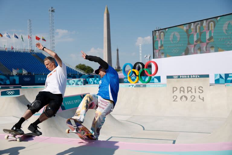 Los patinadores estadounidenses Tony Hawk (izq.) y Mark González practican en el parque antes de las preliminares del skate callejero masculino 