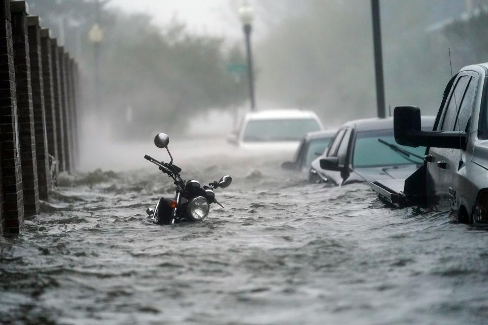 Floodwaters move on the street, Wednesday, Sept. 16, 2020, in Pensacola, Fla.