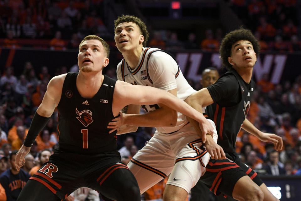 Rutgers' Oskar Palmquist (1), and Derek Simpson, right, vie for a rebound against Illinois' Coleman Hawkins, middle, during the first half of an NCAA college basketball game, Saturday, Feb. 11, 2023, in Champaign, Ill. (AP Photo/Michael Allio)