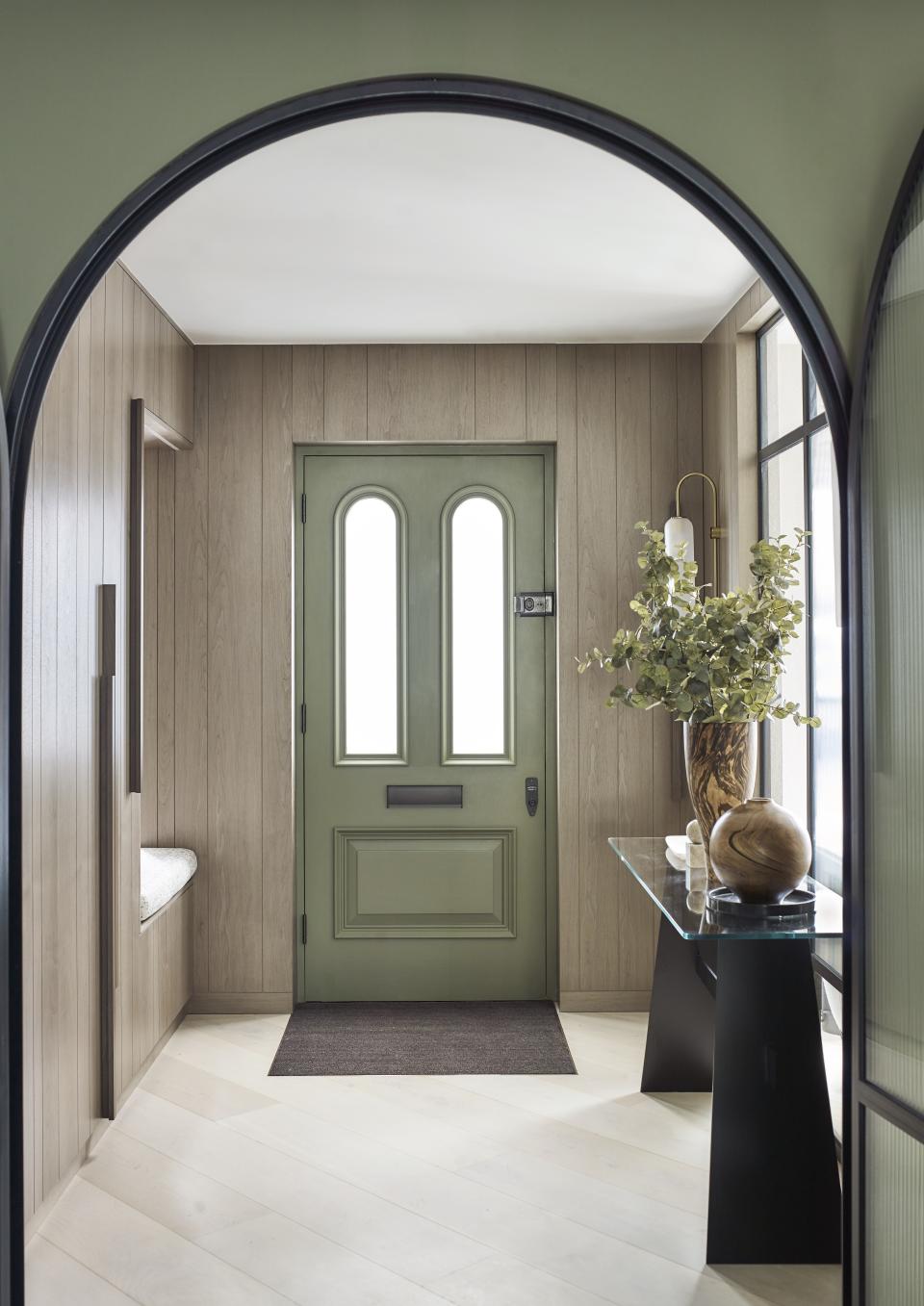 Panelled hallway with green front door