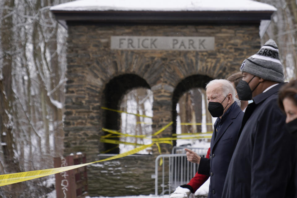 FILE - President Joe Biden visits the site where the Fern Hollow Bridge collapsed Jan. 28, 2022, in Pittsburgh's East End. Pittsburgh Mayor Ed Gainey, second from right, and Commerce Secretary Gina Raimondo, right, look on. The Fern Hollow Bridge became a symbol of the country's troubled infrastructure, collapsing into a ravine earlier this year just before President Joe Biden visited the city. Biden hopes to turn the bridge into a symbol of success for his administration when he returns to Pittsburgh on Thursday, Oct. 20, less than three weeks before the midterm elections. (AP Photo/Andrew Harnik, File)
