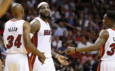 Mar 3, 2014; Miami, FL, USA; Miami Heat small forward LeBron James (6) is congratulated by Miami Heat shooting guard Ray Allen (34) and Miami Heat point guard Norris Cole in the second half of a game against the Charlotte Bobcats at American Airlines Arena. Robert Mayer-USA TODAY Sports