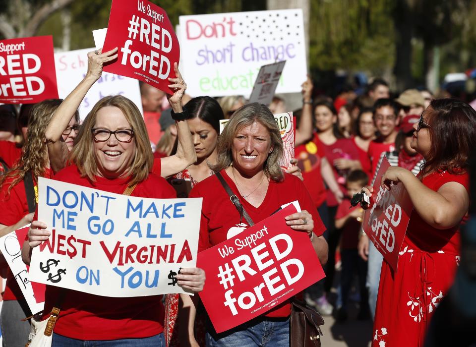 Teachers and advocates for public education march at the Arizona Capitol