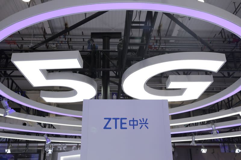 The ZTE logo and a sign for 5G are seen at the World 5G Exhibition in Beijing