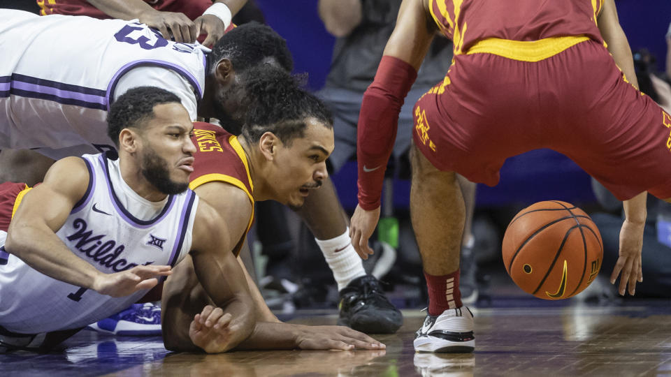 Kansas State's Marquis Nowell, far left, and Iowa State's Robert Jones, middle, scramble for a loose ball during the first half of an NCAA college basketball game on Saturday, Feb. 18, 2023, in Manhattan, Kan. (AP Photo/Travis Heying)