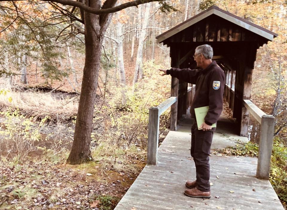 Project Manager Karl Stromayer stands on the covered bridge that nature enthusiasts will be able to enjoy once the Rachel Carson National Wildlife Refuge opens its new visitor center and office complex at 188 Brown Street in Kennebunk, Maine.