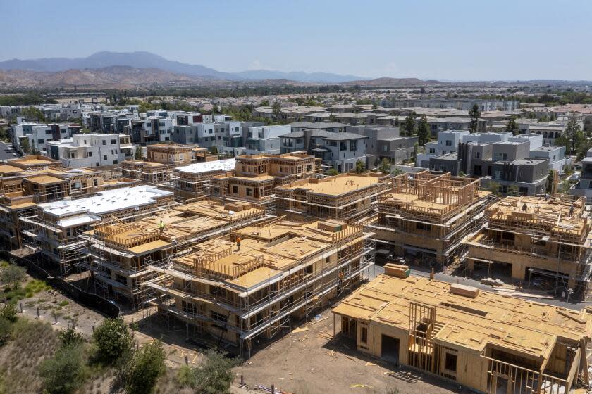 Irvine, CA - August 09: An aerial view of workers constructing new homes in Irvine on Monday, Aug. 9, 2021. (Allen J. Schaben / Los Angeles Times)