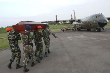 Indonesian air force soldiers carry the coffin of a victim of an Indonesian military C-130B Hercules aircraft that crashed into a residential area to another cargo plane for transport home at a military airbase in Medan, North Sumatra, Indonesia July 2, 2015 in this photo taken by Antara Foto. REUTERS/Irsan Mulyadi/Antara Foto