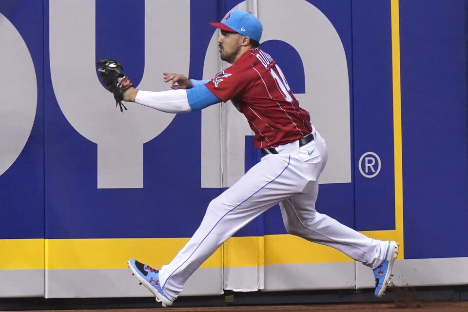 Miami Marlins left fielder Adam Duvall catches a ball hit by New York Mets' Dominic Smith during the third inning of a baseball game, Saturday, May 22, 2021, in Miami. (AP Photo/Lynne Sladky)