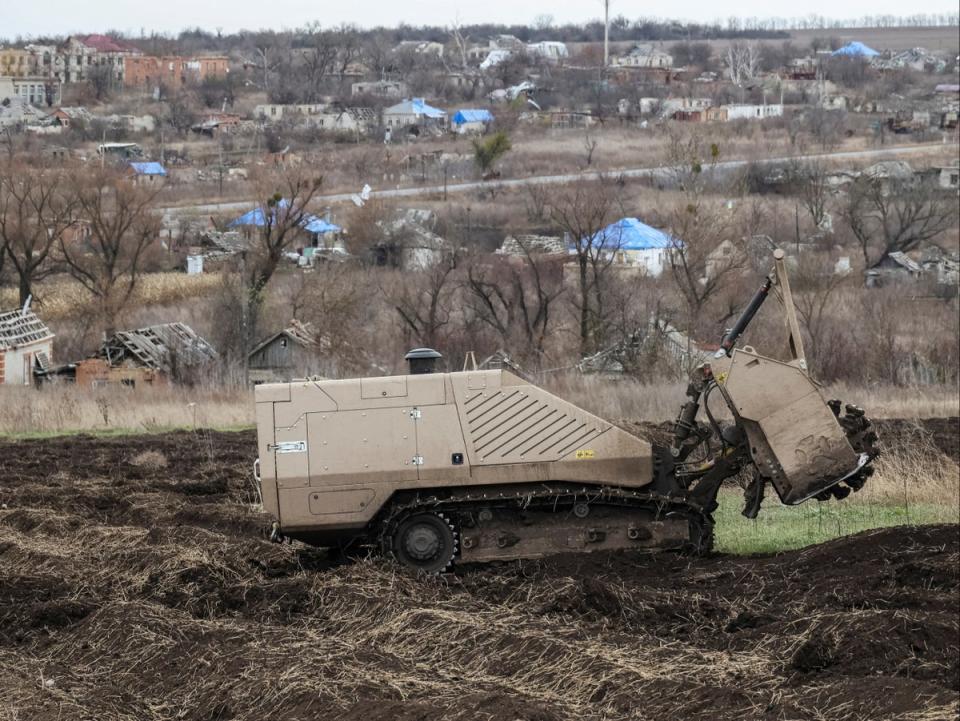 A remote-controlled demining vehicle GCS 200 works on a field near the village of Kamianka in eastern Ukraine (Reuters)