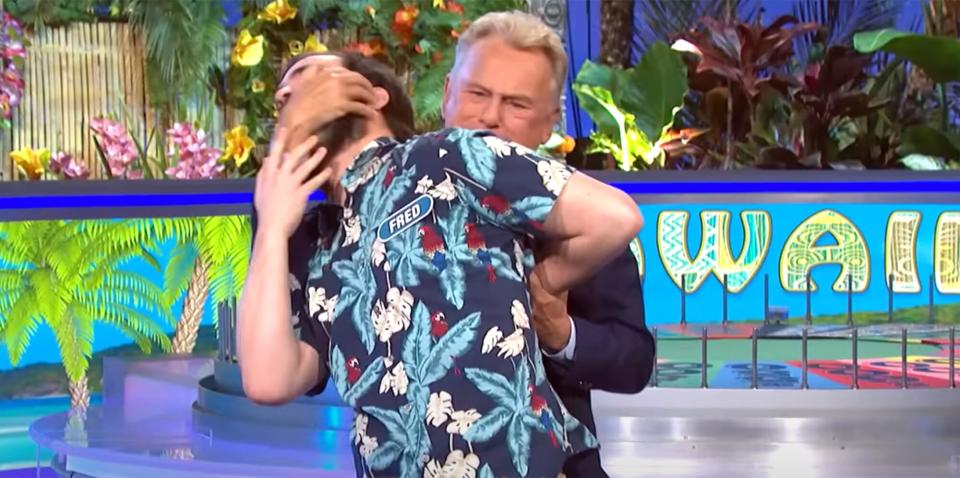 Pat Sajak wrestles a contestant on 'Wheel of Fortune'