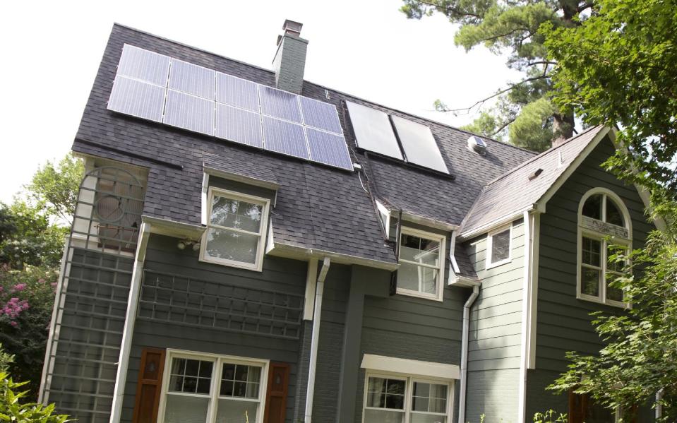 This Thursday, July 18, 2013 photo shows a house owned by Ketch Ryan with solar panels installed on the roof in Chevy Chase, Md. To help neighbors, Ryan helped found a cooperative, Common Cents Solar. The first thing is to get an assessment of your roof and whether it’s viable for solar. The condition of the roof, the type of roofing material used, and the angle are among the things that need to be looked at. (AP Photo/Manuel Balce Ceneta)