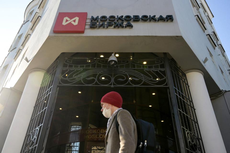 A man walks past the Moscow's stock market building in downtown Moscow on February 28, 2022. - Russia's central bank announced on February 28, 2022 it was raising its key interest rate to 20 percent from 9.5 percent as the West pummelled the country with sanctions over Moscow's invasion of Ukraine. (Photo by Natalia KOLESNIKOVA / AFP) (Photo by NATALIA KOLESNIKOVA/AFP via Getty Images)