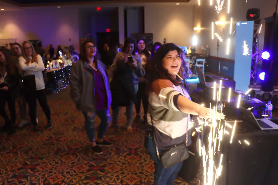 Sabrina Saenz checks out a cold spark machine on display at the 2023 Amarillo Bridal Show held at the Amarillo Civic Center Sunday afternoon.