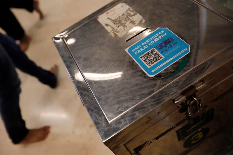 An alms box with a QR code for digital payments is seen after Friday prayers at Istiqlal mosque in Jakarta