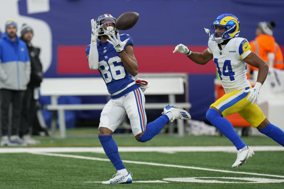New York Giants wide receiver Darius Slayton (86) catches a touchdown pass against Los Angeles Rams cornerback Ahkello Witherspoon (44) during the second half an NFL football game, Sunday, Dec. 31, 2023, in East Rutherford, N.J. (AP Photo/Seth Wenig)