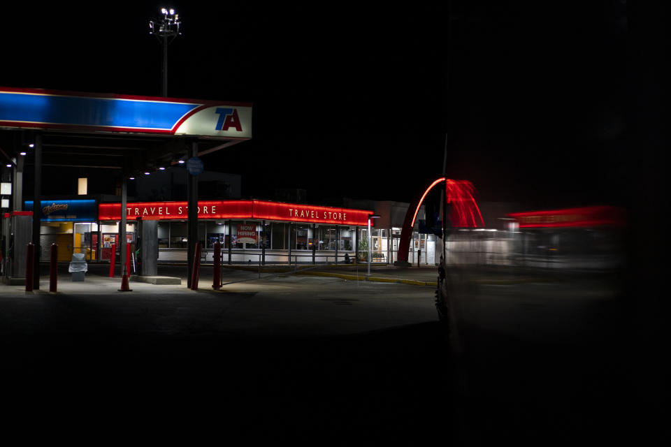 In this April 4, 2020, photo, the TA Travel Center truck stop in Foristell, Mo., is dark and quiet as most truckers sleep. During the coronavirus outbreak, truckers continue work so the supply chain is not disrupted. (AP Photo/Carolyn Kaster)