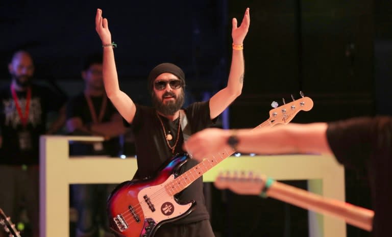 Avo Demerjian, bassist and back-up vocalist of Jordanian band Autostrad, performs on stage at the Dubai International Marine Club during a music festival, on April 7, 2017