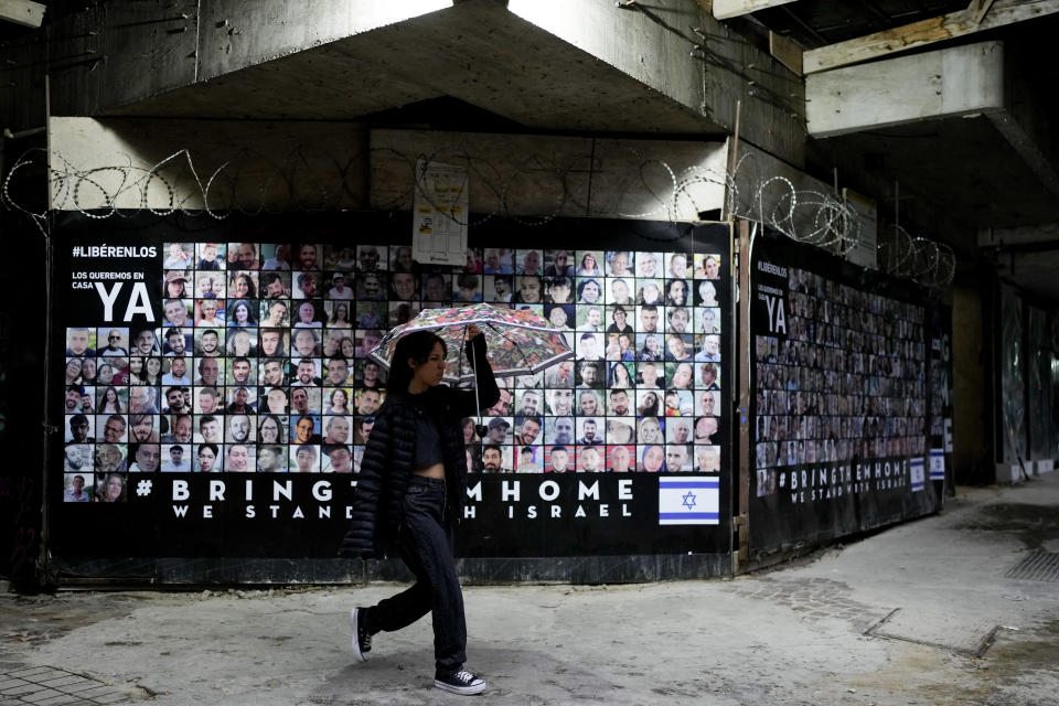 Photos of people kidnapped by Hamas cover a wall and demand their release in Buenos Aires, Argentina, Monday, Feb. 26, 2024. When Hamas militants attacked numerous targets in Israel on Oct. 7, 2024, killing hundreds and abducting others, many Argentines were reminded of the 1994 bombing attack on the AMIA Jewish community center that killed 85 people. (AP Photo/Natacha Pisarenko)