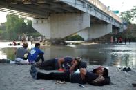 Migrant travelling to the U.S. rest by the Suchiate river at the border between Guatemala and Mexico, in Tecun Uman